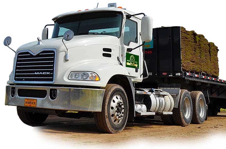 Large white truck delivering Zoysiagrass and pallets of sod.